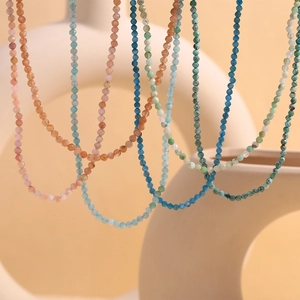 Close-up of colorful faceted bead necklaces with 18K gold-plated stainless steel