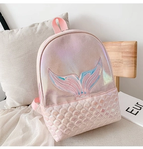 Detail of laser shiny pink mermaid backpack featuring embroidered tail and scale textures