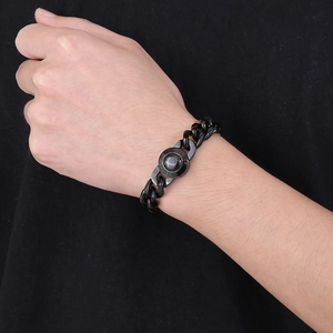 Close-up of black 13mm Cuban link bracelet with CNC diamond-set buckle on male wrist