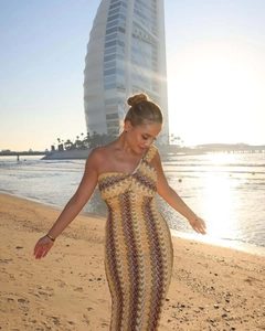 Detail of slim fit one-shoulder lace beach dress with wavy geometric print in sunset light