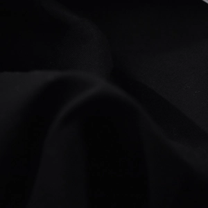 Detailed macro texture of black woven fabric showing the premium soft textile material