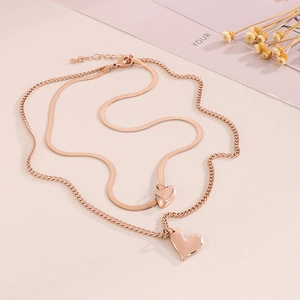 Double layer rose gold stainless steel heart pendant necklace on pink magazine background