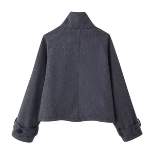 Back view of short dark grey wool jacket with stand collar and raglan sleeves