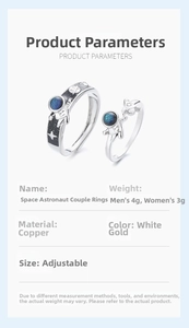 Detailed view of astronaut couple rings with blue stone inlay and adjustable bands
