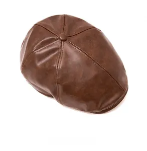Top view of deep brown faux leather newsboy cap showing fine lychee grain texture