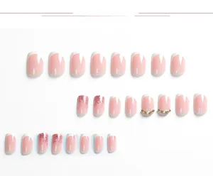 Detailed flat lay of 24pcs pink French press-on nails with white tips and pearl accents