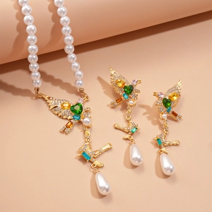 Macro detail of bird jewelry set featuring multicolor zircon and heart stones with pearls