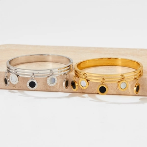 Three-layer stainless steel bangle with Roman numeral pendants in gold and silver finish