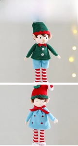 Detail of Christmas elf plush dolls with red bows and striped socks for holiday tree decor