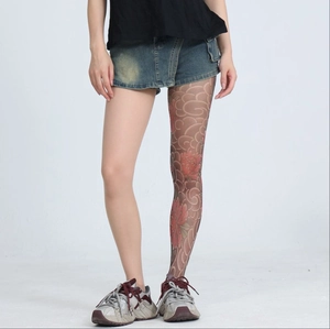 Macro view of sheer tights featuring traditional red peony and grey cloud tattoo patterns