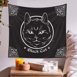 Detail of black cat tapestry with crescent moon and vintage patterns in room decor