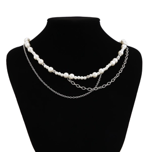 Close-up of double-layer men's necklace with white pearls and silver metal fringe chain