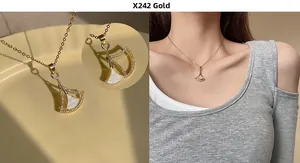 Detailed view of a gold fan pendant necklace with white shell inlay and paved crystals