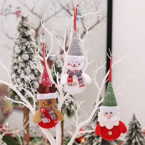 Christmas plush ornaments with snowman and reindeer hanging on a white festive tree branch