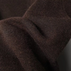 Detail shot of premium deep brown knit fabric showing soft texture and fine stitching