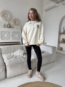 Oversized cream half-zip sweatshirt with Sports Club print and black leggings