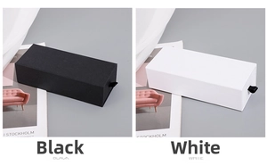 Detail of premium drawer gift boxes in textured white and matte black with ribbon pulls