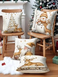 Detail showing linen Christmas pillow covers with reindeer and snowman prints in a cozy room