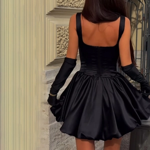 Elegant black satin bubble hem mini dress with long gloves and sleek bodycon silhouette