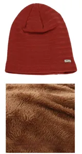 Détail du bonnet d'hiver en maille avec motif fléché, étiquette en métal et doublure polaire