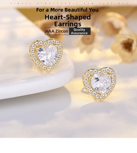 Close-up of heart-shaped earrings featuring AAA cubic zirconia in a gold setting