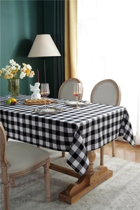 Detailed view of black and white checkered tablecloth in a festive dining table setting