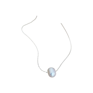 Minimalist freshwater pearl pendant necklace with elegant silver snake chain on white background