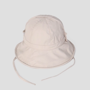 Detail of beige cotton sun hat featuring precise stitching and adjustable windproof strap
