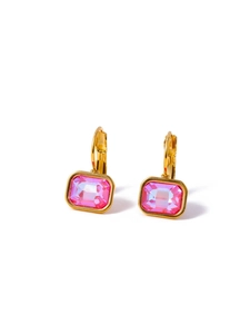 Detail of gold huggie earrings featuring large faceted pink rectangular zircon stones