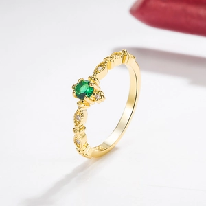 Exquisite 14k gold ring featuring a round emerald centerpiece and side diamond accents