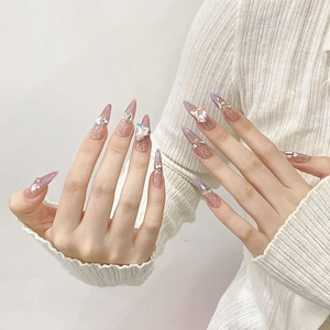 Elegant stiletto press-on nails with pink purple gradient and 3D heart crystal charms
