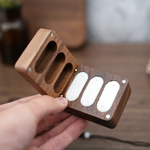 Detailed view of triple-slot black walnut ring box with soft white velvet lining