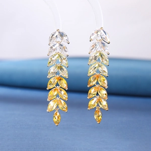 Macro detail of leaf drop earrings featuring white to yellow gradient marquise cubic zirconia