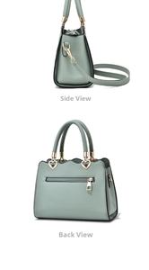 Close-up of mint green embroidered faux leather handbag with heart-shaped metal details