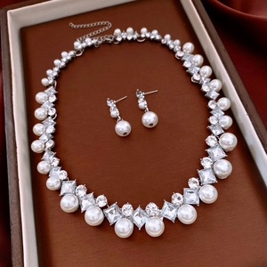 Macro view of French vintage pearl and zircon jewelry set on luxury brown leather display