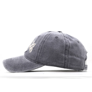 Detail of dark gray washed cotton baseball cap with side letter embroidery and metal buckle
