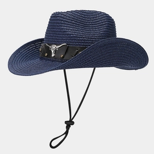 Detail of navy straw cowboy hat featuring silver bull head emblem and leather band
