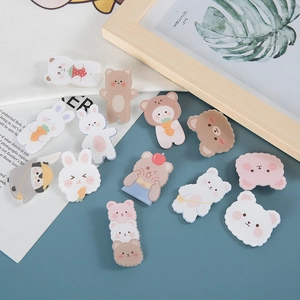 Set of cute acrylic animal badges featuring brown bear and white bunny on blue background