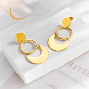 Golden triple-layered geometric drop earrings with crescent moon charm on white stone