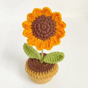 Handmade knitted sunflower potted plant with yellow petals in a woven pot for car decor