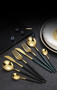 Close-up of golden stainless steel cutlery set with elegant black matte handles