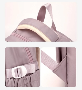Detail view of reinforced purple nylon backpack straps with durable adjustment buckles