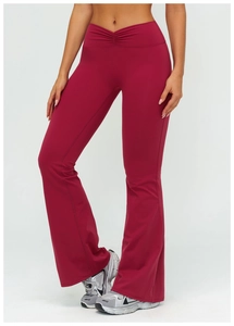 Macro view of burgundy high-waisted flared yoga pants with V-shaped pleated waist details