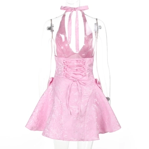 Detail of pink halter dress back featuring intricate floral jacquard and ribbon tie design