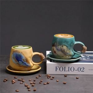 Detailed view of handmade ceramic coffee mugs with hemp rope handles and latte art