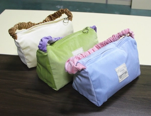 Detailed corduroy makeup bags with contrast ruffles handles in multiple colors