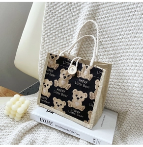 Detailed close-up of bear canvas tote bag showing the linen texture and woven handles