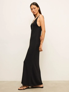 Side view of a slim-fit black sleeveless knit maxi dress with a soft elegant drape