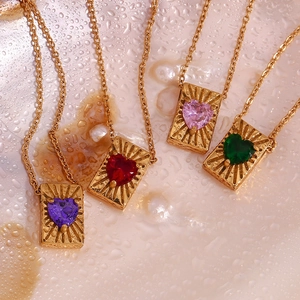 Detail of 18K gold-plated card pendants with colorful heart-shaped zircon stones