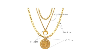 Detailed view of 18K gold plated layered necklace with lion emblem and moon pendants